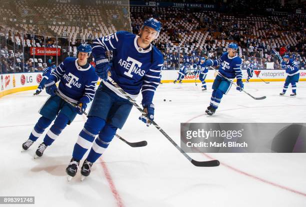 James van Riemsdyk and Matt Martin skate during warm up prior to the game against the Carolina Hurricanes at the Air Canada Centre on December 19,...