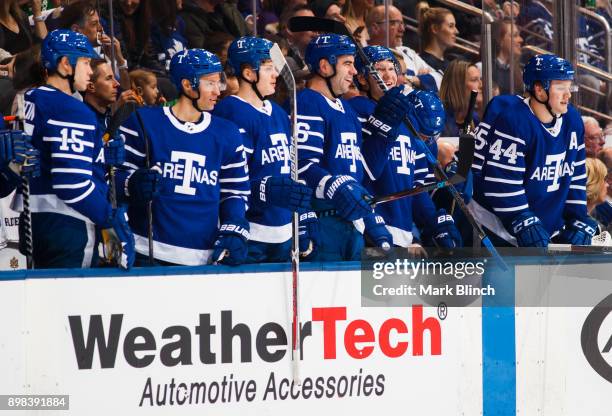 Morgan Rielly, Andreas Borgman, Roman Polak, Kasperi Kapanen, Dominic Moore and Matt Martin of the Toronto Maple Leafs look on in a break from the...