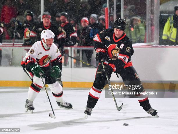 Ottawa Senators alumni Chris Phillips stickhandles the puck with Magnus Arvedson chasing during the 2017 Scotiabank NHL100 Classic Ottawa Senators...