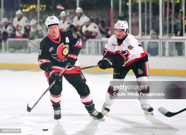 Ottawa Senators alumni Chris Neil pulls the puck away from Randy Robitaille during the 2017 Scotiabank NHL100 Classic Ottawa Senators Alumni Game on...