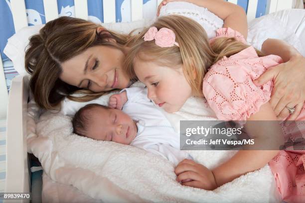 Mira Sorvino poses with daughter Mattea Backus and newborn son Holden Backus during an at home photo shoot on July 1, 2009 in Malibu, California.