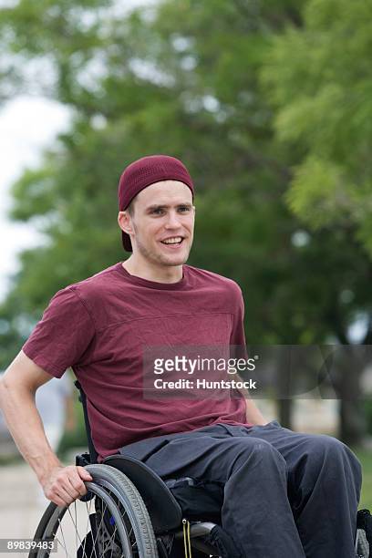 disabled man in a wheelchair - man in wheelchair stock pictures, royalty-free photos & images