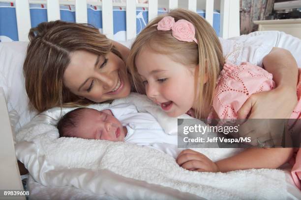 Mira Sorvino poses with daughter Mattea Backus and newborn son Holden Backus during an at home photo shoot on July 1, 2009 in Malibu, California.