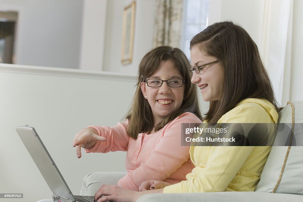 Two teenage girls working on a laptop