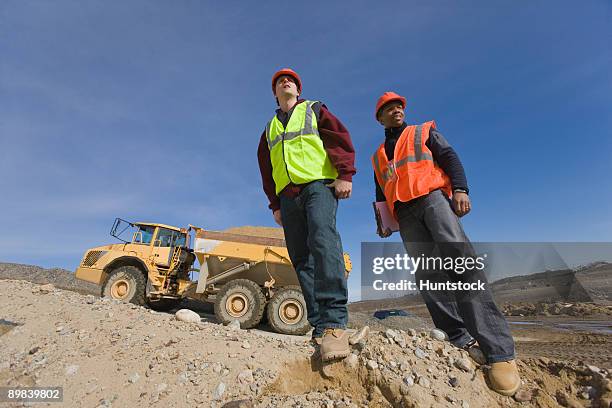 two engineers at a construction site - white dump truck stock pictures, royalty-free photos & images