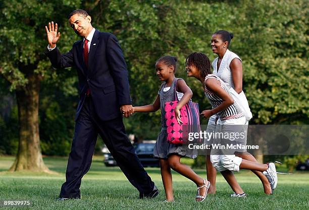 President Barack Obama returns to the White House with his family including daughters Sasha, Malia and U.S. First Lady Michelle Obama August 17, 2009...