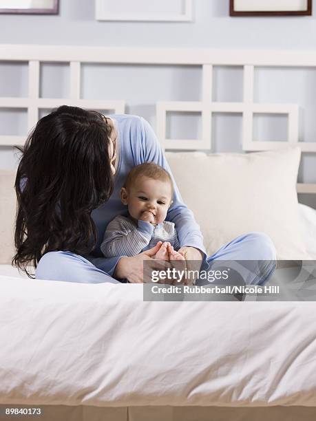 mother and baby on a bed - 8897 stock pictures, royalty-free photos & images