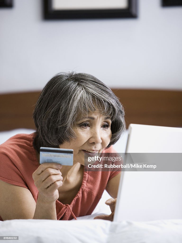Senior woman making an online purchase with her credit card