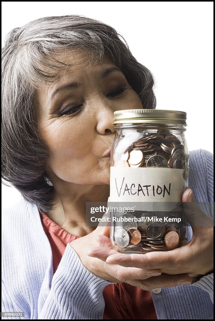 Woman with a jar full of coins