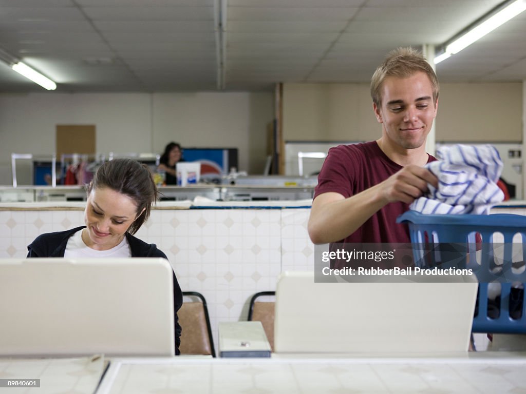 Man and woman at a laundromat