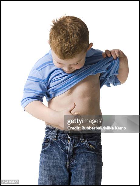 boy looking at his belly button - belly button ストックフォトと画像