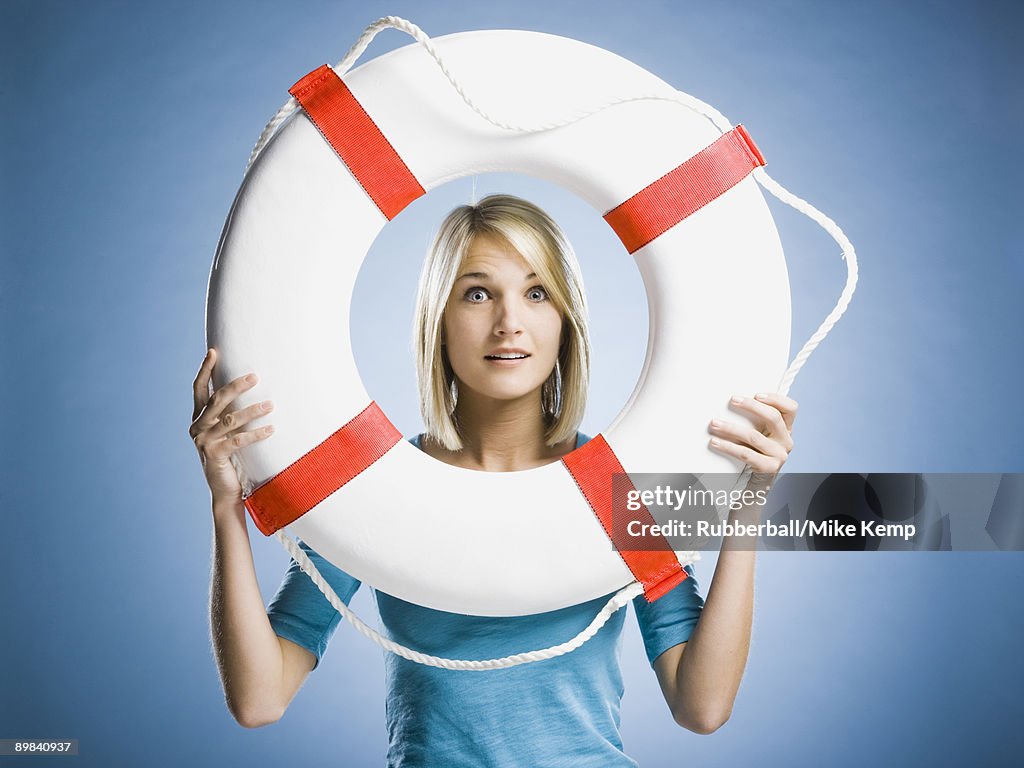 Woman looking through a life preserver