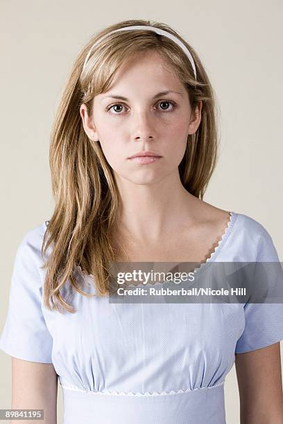 woman in a blue dress with a straight face - 16 17 girl blond hair stock pictures, royalty-free photos & images