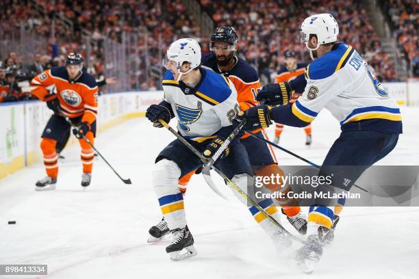 Jujhar Khaira and Leon Draisaitl of the Edmonton Oilers battle against Alexander Steen and Joel Edmundson of the St. Louis Blues at Rogers Place on...