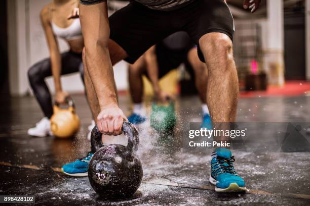 lifting kettlebells - crossfit training stock pictures, royalty-free photos & images