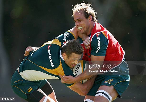 Matt Giteau is tackled by Phil Waugh during an Australian Wallabies training session at Leichhardt Oval on August 18, 2009 in Sydney, Australia.