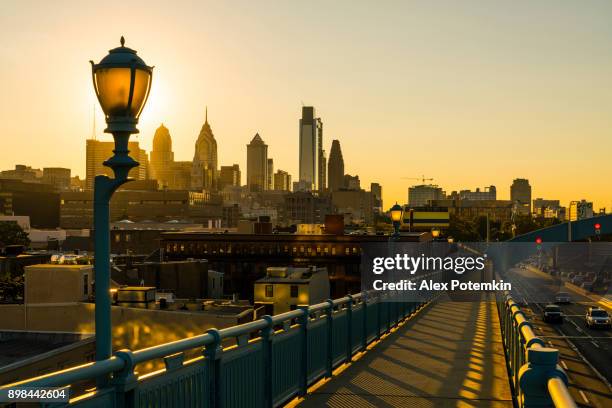 philadelpia downtown at sunset. the view from the benjamin franklin bridge. - philadelphia skyline stock pictures, royalty-free photos & images