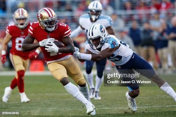 Wide receiver Marquise Goodwin of the San Francisco 49ers breaks a tackle from cornerback Adoree' Jackson of the Tennessee Titans during the fourth...