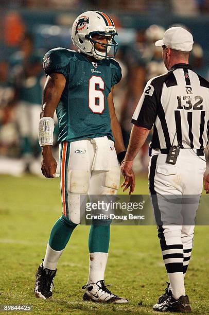 Quarterback Pat White of the Miami Dolphins prepares to ask referee John Parry for a time-out while taking on the Jacksonville Jaguars during a...