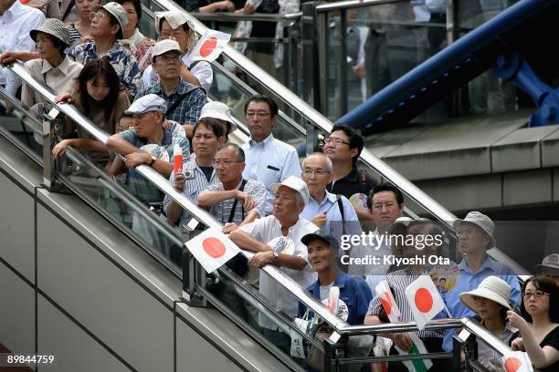 People wait to listen to a stump speech by Taro Aso, Prime Minister and President of the Liberal Democratic Party , during an election campaign in...
