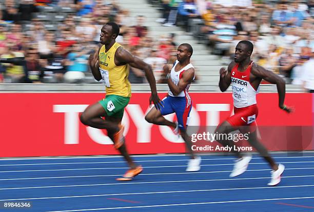 Usain Bolt of Jamaica, Eddy De Lepine of France and Sam Effah of Canada compete in the men's 200 Metres Heats during day four of the 12th IAAF World...