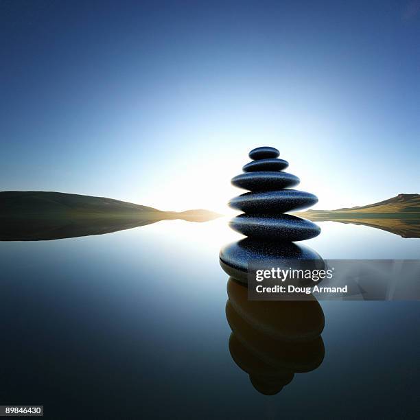 stack of balanced rocks in lake - balance stone stock illustrations