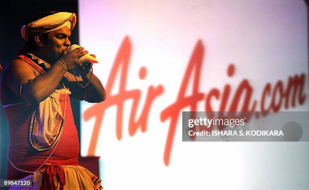 Sri Lankan Kandyan dancers plays on a conch shell at a Malaysian budget carrier AirAsia press conference in Colombo on August 18, 2009. AirAsia added...