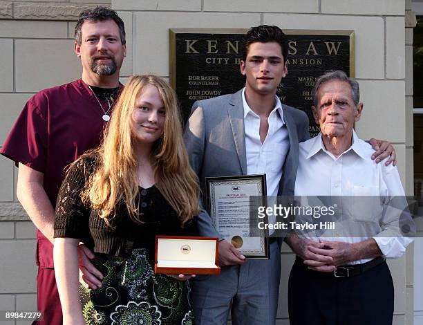 Sean O'Pry poses with his grandfather, father, John O'Pry and sister as they attend a proclamation ceremony at City Hall on August 17, 2009 in...