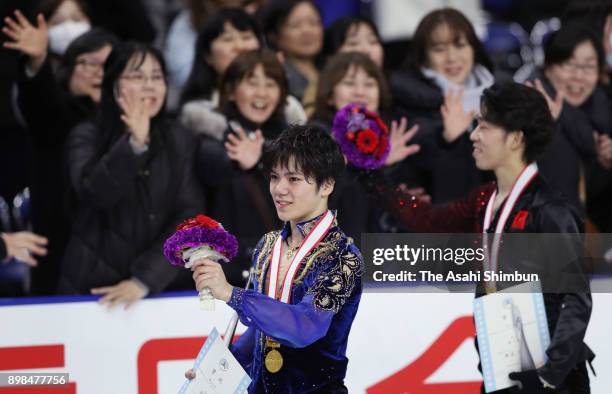 Gold medalist Shoma Uno and bronze medalist Takahito Mura applaud fans after the medal ceremony for the Men's Singles during day four of the 86th All...