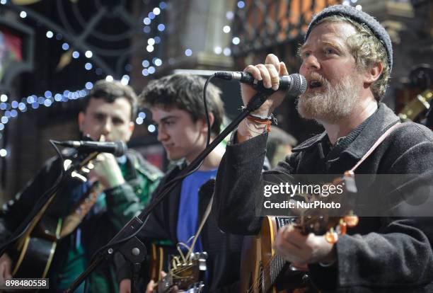 Glen Hansard takes part in the annual Christmas Eve busk in aid of the Dublin Simon Community outside the Gaiety Theater in Dublin. Hundreds attended...