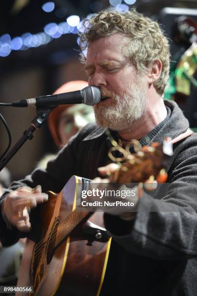 Glen Hansard takes part in the annual Christmas Eve busk in aid of the Dublin Simon Community outside the Gaiety Theater in Dublin. Hundreds attended...