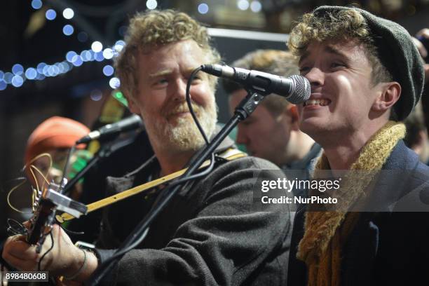Glen Hansard and David Keenan take part in the annual Christmas Eve busk in aid of the Dublin Simon Community outside the Gaiety Theater in Dublin....