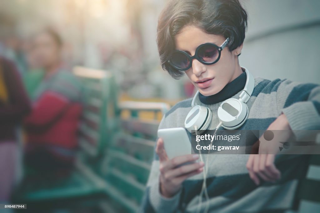 Beautiful urban young woman using smart phone.