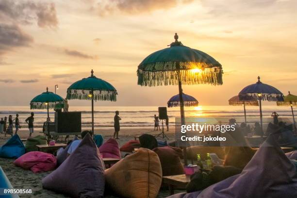 sunset at seminyak beach bali, indonesia - kuta stock pictures, royalty-free photos & images