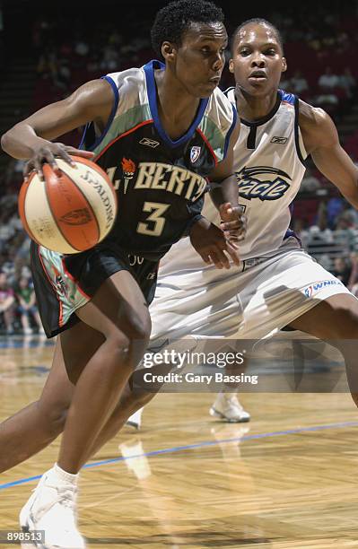 Crystal Robinson of the New York Liberty drives past Elaine Powell of the Orlando Miracle in the game on June 23, 2002 at TD Waterhouse Centre in...