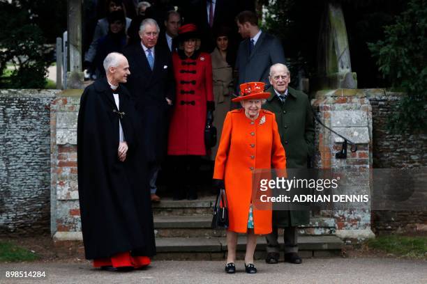 Britain's Queen Elizabeth II and Britain's Prince Philip, Duke of Edinburgh lead out other members of the family with Reverend Canon Jonathan Riviere...