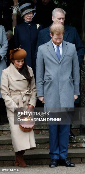 Actress and fiancee of Britain's Prince Harry Meghan Markle curtseys as Britain's Prince Harry bows as they see off Britain's Queen Elizabeth II...