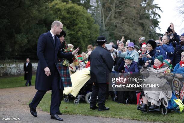 Britain's Prince William, Duke of Cambridge, and Britain's Catherine, Duchess of Cambridge, greet well-wishers as they leave after attending the...