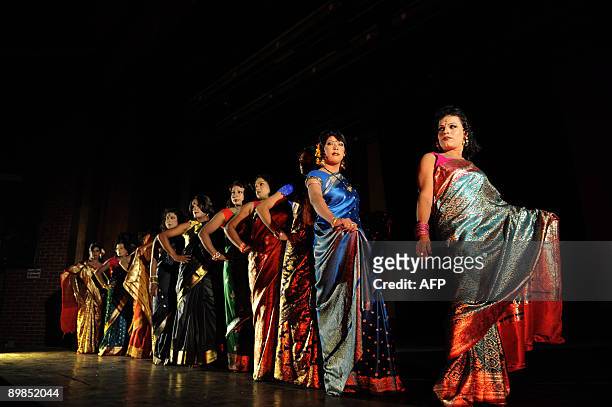 Bangladeshi eunuchs, castrated males, locally named "Hijra" display outfits during a fashion show in Dhaka on August 18, 2009. A Bangladeshi...