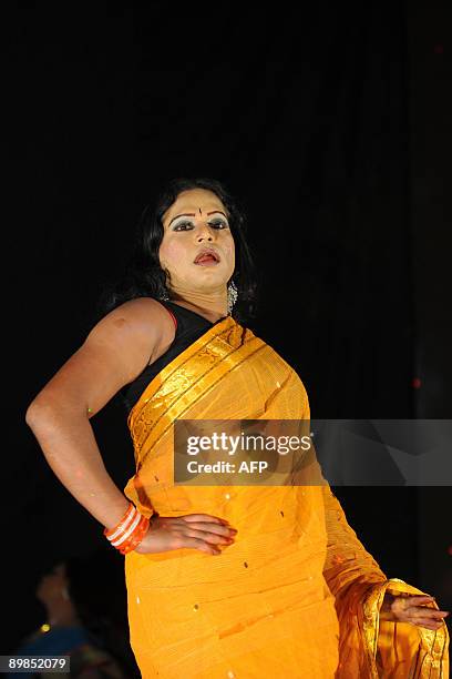 Bangladeshi eunuch, castrated male, locally named "Hijra" displays an outfit during a fashion show in Dhaka on August 18, 2009. A Bangladeshi...