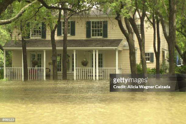 Flooded home near the Olmos Dam is shown July 3, 2002 in San Antonio, Texas. The neighborhood has been flooded since heavy rains pounded much of the...