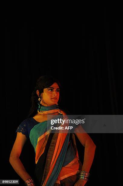 Bangladeshi eunuch, castrated male, locally named "Hijra" displays an outfit during a fashion show in Dhaka on August 18, 2009. A Bangladeshi...
