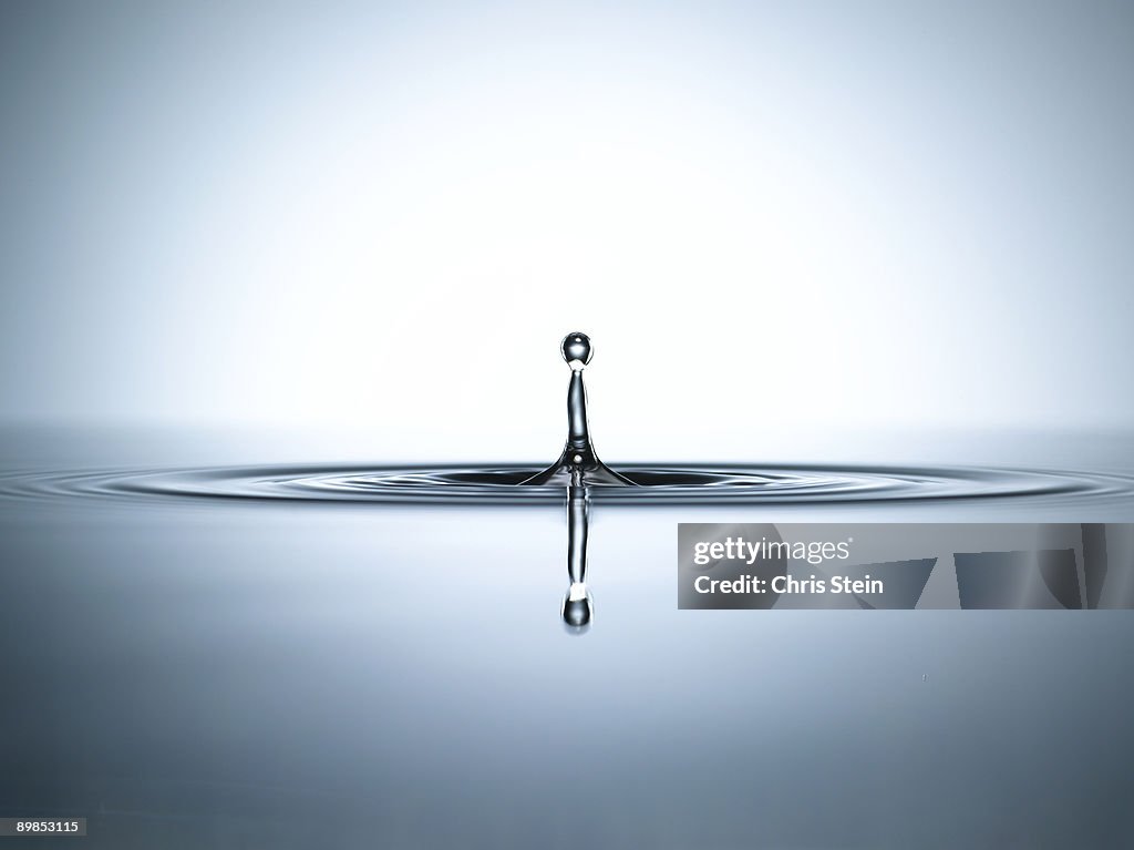 Water droplet in a pool of water