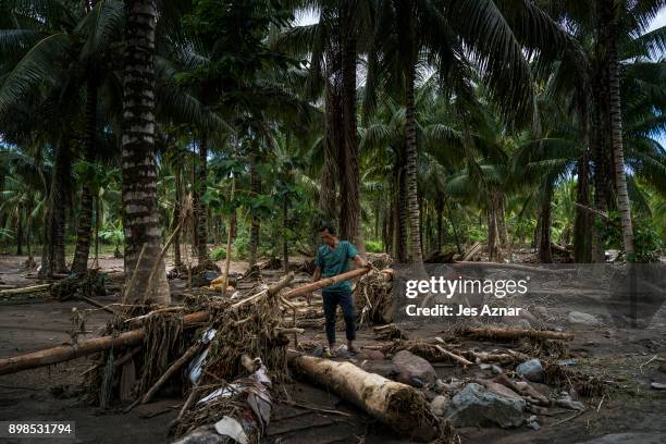 Residents looking at the destruction in their village on December 25, 2017 in Salvador, Lanao del Norte, Philippines. Tropical Storm Tembin swept...
