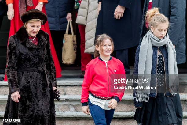 Queen Sonja of Norway, Emma Tallulah Behn of Norway and Leah Isadora Behn of Norway leave the Christmas service at Holmenkollen Chapel on December...