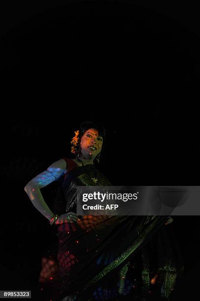 Bangladeshi eunuch, castrated male, locally named "Hijra" displays an outfit during a fashion show in Dhaka on August 18, 2009. A Bangladeshi...