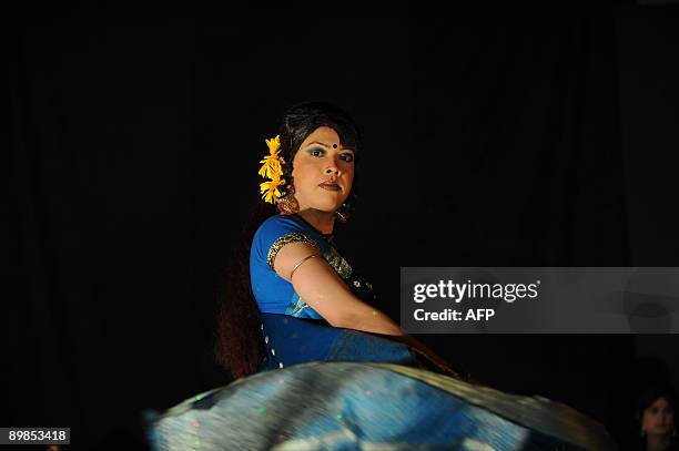 Bangladeshi eunuch, castrated male, locally named "Hijra" displays an outfit during a fashion show in Dhaka on August 18, 2009. A Bangladeshi...