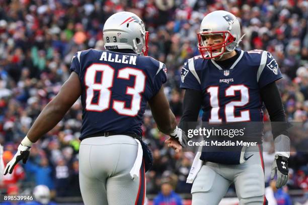 Tom Brady of the New England Patriots and Dwayne Allen celebrate during the game against the Buffalo Bills Gillette Stadium on December 24, 2017 in...