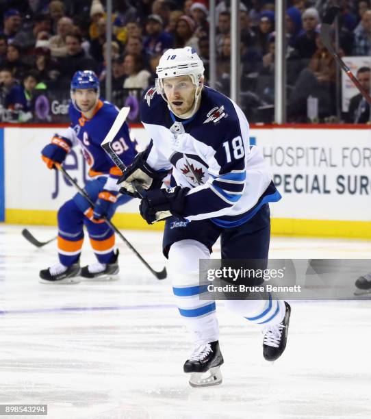 Bryan Little of the Winnipeg Jets skates against the New York Islanders at the Barclays Center on December 23, 2017 in the Brooklyn borough of New...