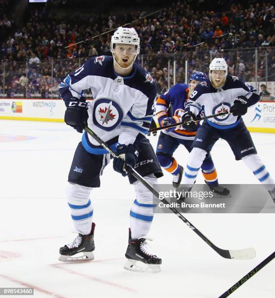 Kyle Connor of the Winnipeg Jets skates against the New York Islanders at the Barclays Center on December 23, 2017 in the Brooklyn borough of New...